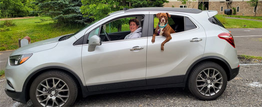 Owner and dog in car for vallet service at Town & Country Pet Care Center for Dog Daycare near Newtown, PA